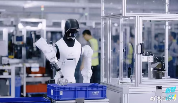 Humanoid robot executing automated machine tending and parts handling at an industrial workstation